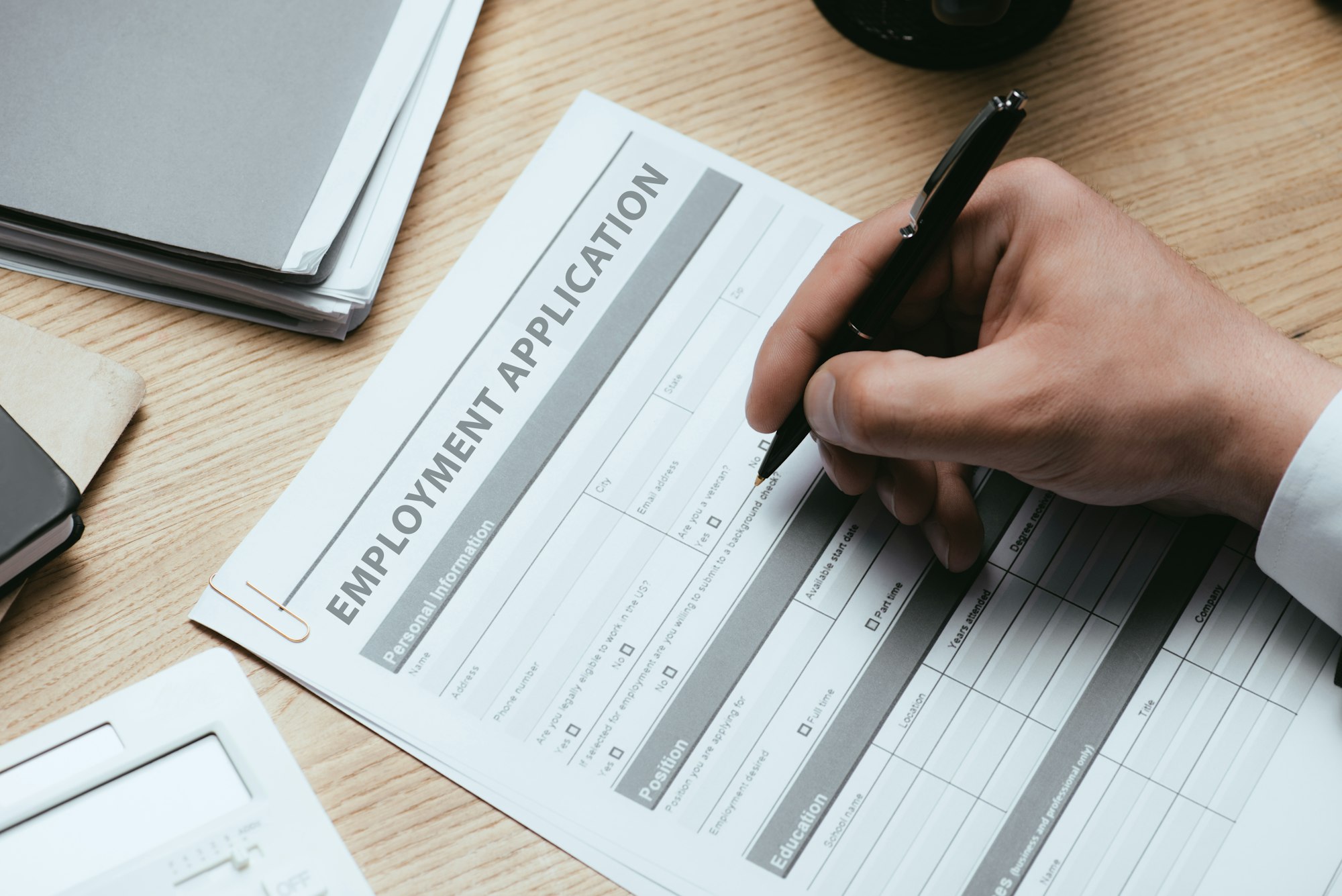 cropped view of man filling in Employment Application Agreement Form Concept