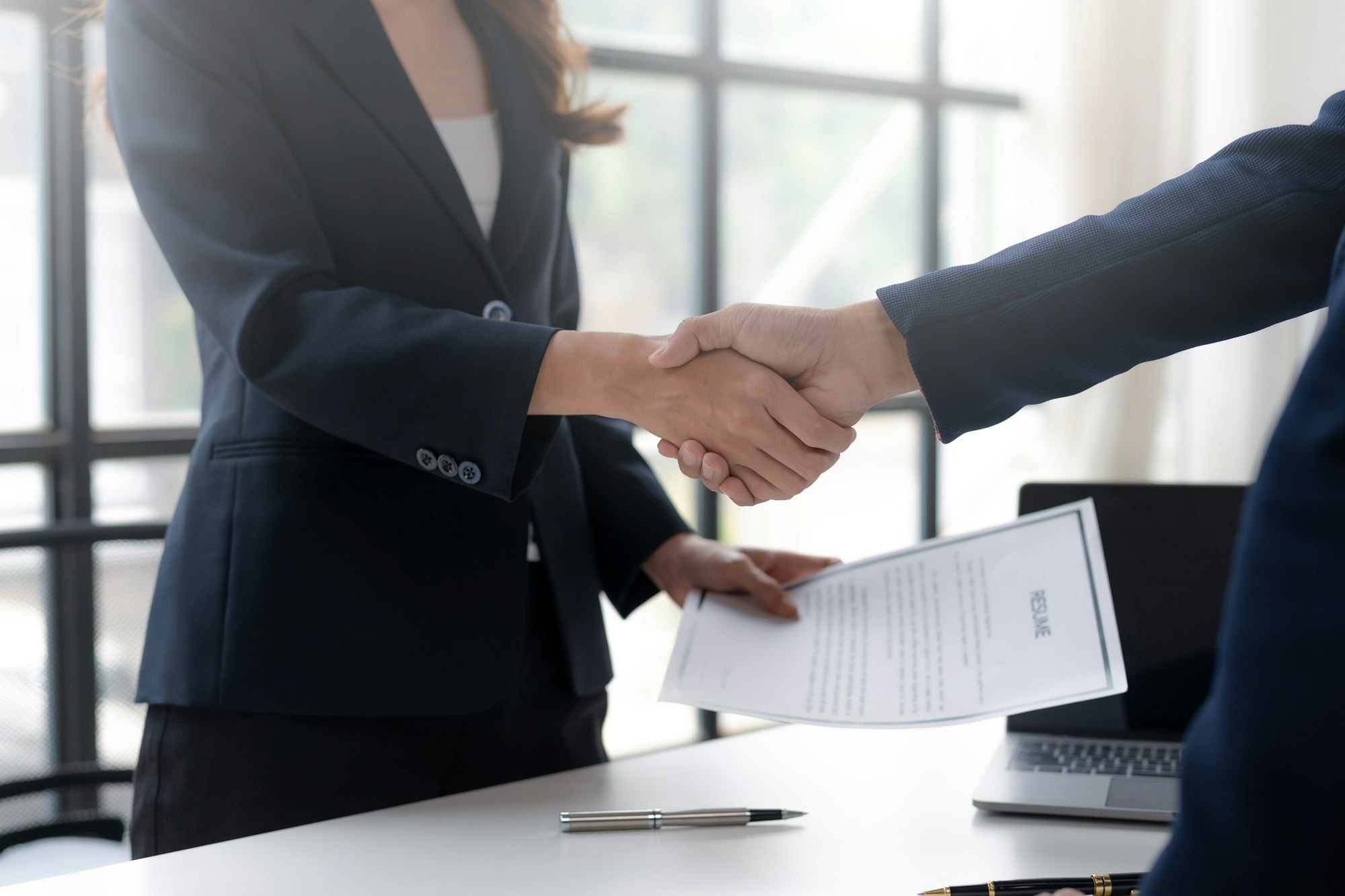 Employment and recruitment. Human resources manager shaking hands with job applicants.